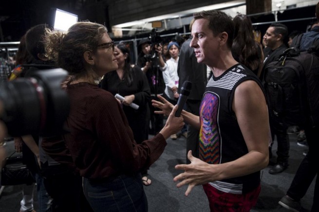 Designer Jeremy Scott speaks to media backstage before presenting his Spring/Summer 2016 collection presentation during New York Fashion Week in New York, September 14, 2015. REUTERS/Andrew Kelly