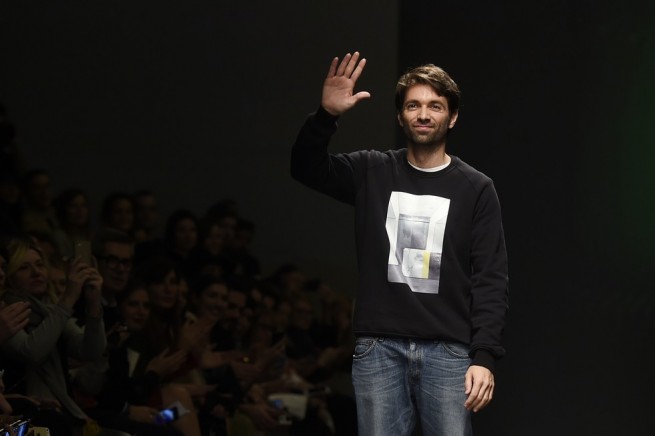 Designers Massimo Giorgetti greets the audience at the end of the show for fashion house MSGM at the women Fall / Winter 2015/16 Milan's Fashion Week on March 1, 2015. AFP PHOTO / OLIVIER MORIN