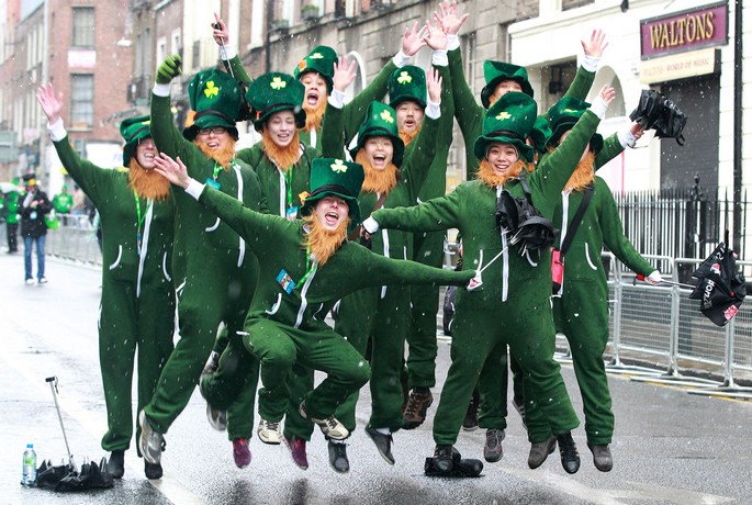 Parade goers dressed as leprechauns jumps up and shout as they prepare to attend St Patrick's Day festivities in Dublin on March 17, 2013. More than 100 parades are being held across Ireland to mark St Patrick's Day, the feast day of the patron saint of Ireland, with up to 650,000 spectators expected to attend the parade in Dublin. Ireland has high hopes that the festivities will bring a much-needed boost to the economy. AFP PHOTO/ PETER MUHLYPETER MUHLY/AFP/Getty Images